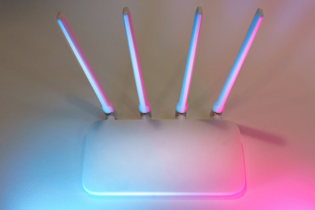 White WiFi router with antennas on a desk in a home